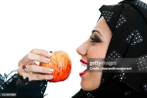 happy arabic girl eating an apple - bahrain people stock pictures, royalty-free photos & images