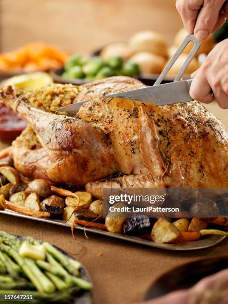 carving a roast turkey - roast chicken table stockfoto's en -beelden