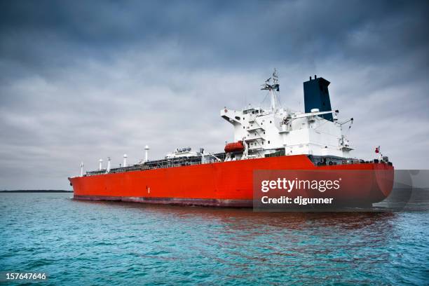 red tanker ship afloat in the ocean - oil tanker stock pictures, royalty-free photos & images