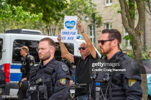 Lone AfD supporter holds up a banner directing his protest against the anti-AfD rally outside the conference centre during the 2023 Federal Congress...