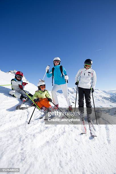 skiing family during short halt - family skiing stock pictures, royalty-free photos & images