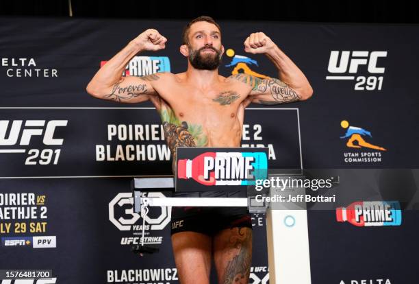 Michael Chiesa poses on the scale during the UFC 291 official weigh-in at Hilton Salt Lake City Center on July 28, 2023 in Salt Lake City, Utah.