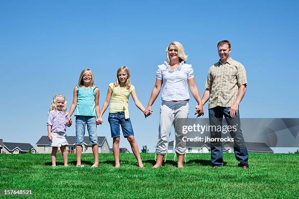 family of five holding hands in neighborhood park - mormonism stock pictures, royalty-free photos & images