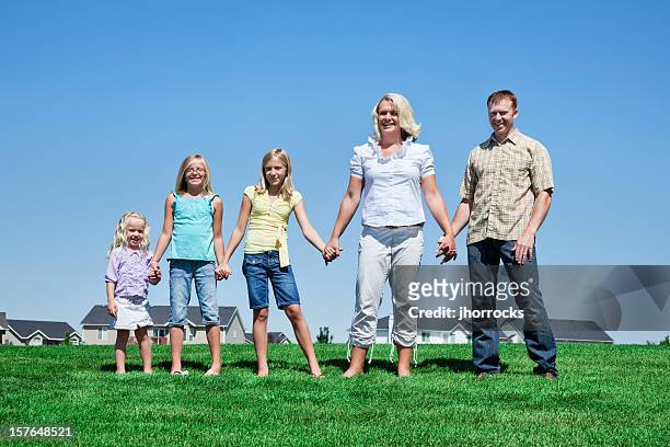família de cinco de mãos dadas num parque da vizinhança - mormonism imagens e fotografias de stock