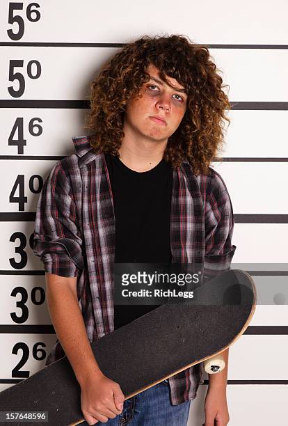 mugshot ein teenager junge mit skateboard - police line up stock-fotos und bilder