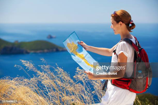 woman with backpack reading map - corfu stock pictures, royalty-free photos & images