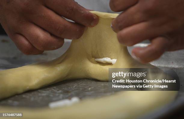 Baker places doll inside a Rosca de Reyes , figurines inside represent baby Jesus, and whoever gets a slice of bread with the figurine is supposed to...