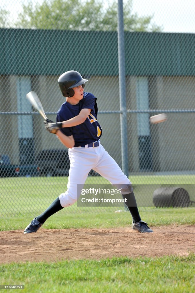 Baseball Player Hitting Ball