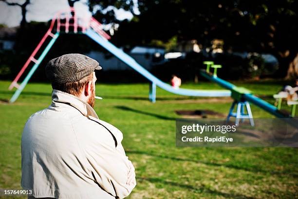 possible pedophile watches a children's playground for potential prey - criminal offence stock pictures, royalty-free photos & images