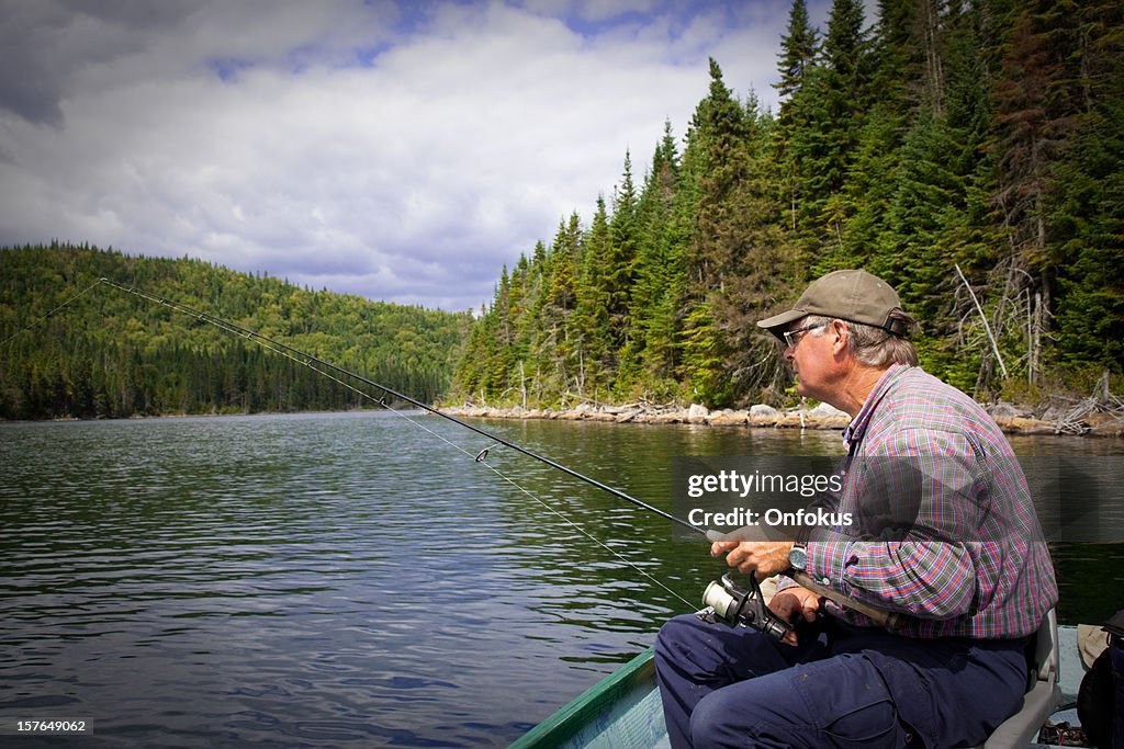 Senior Fisherman Catching a Fish