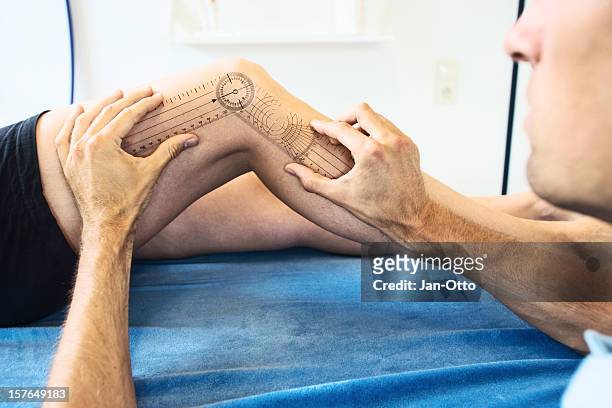 measuring a knee joint - orthopedic surgeon stock pictures, royalty-free photos & images