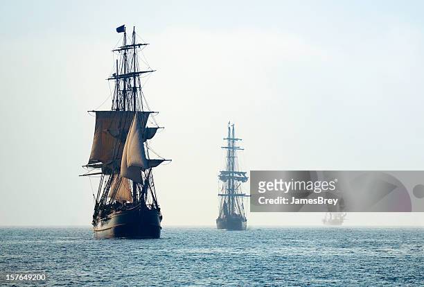 tall ships in the last mists of morning fog - ancient stock pictures, royalty-free photos & images