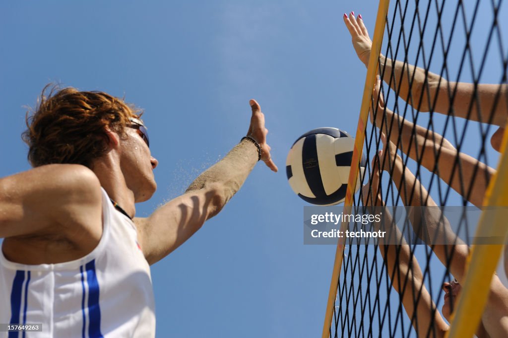 Beach volley action in mid-air