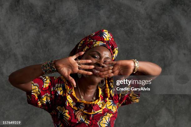 african female dancer/hands in front of face,eyes shut/close up - african tradition stock pictures, royalty-free photos & images