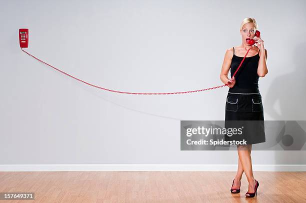 quirky blonde with red telephone - landline phone woman stock pictures, royalty-free photos & images