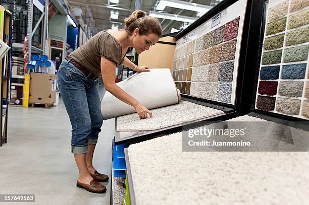 a young woman selecting a carpet samples - carpet stock pictures, royalty-free photos & images