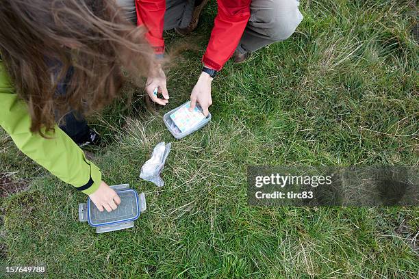 young man and woman geocaching - geocaching stock pictures, royalty-free photos & images