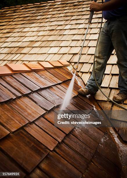 man pressure washing a roof - cleaning gutters stock pictures, royalty-free photos & images