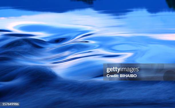 relaxing, swirling pool of blue water - flowing stream stock pictures, royalty-free photos & images