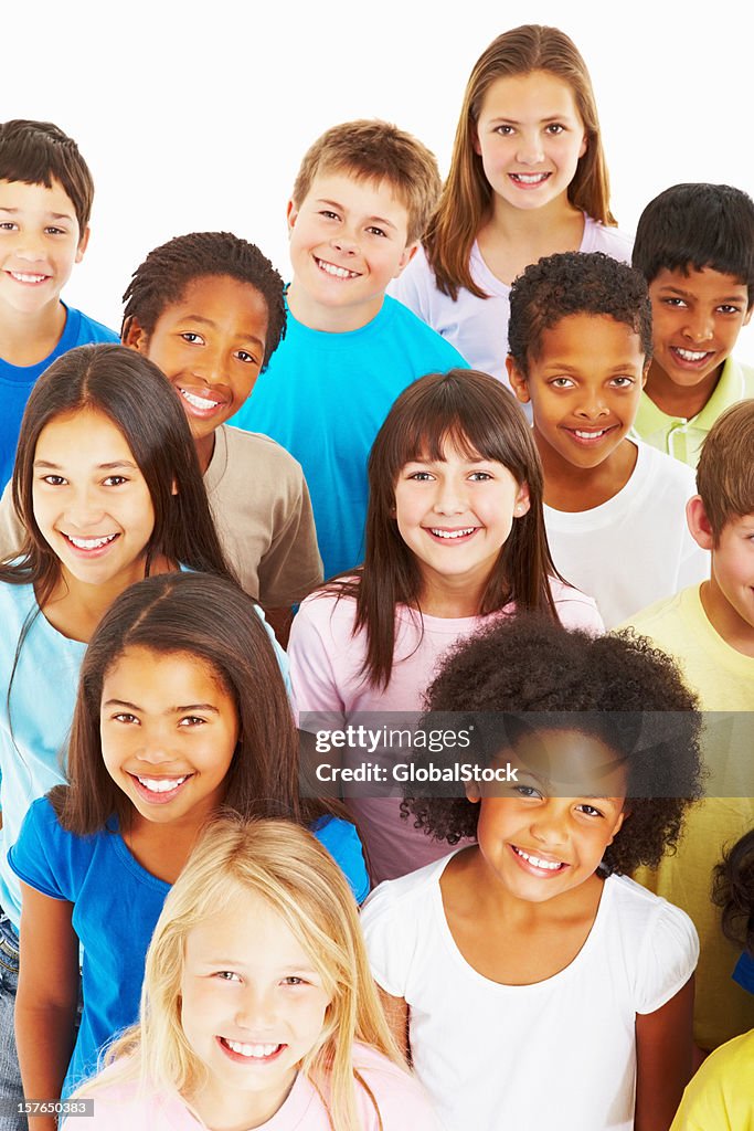 Close-up of multi ethnic kids smiling against white