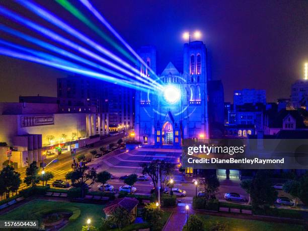 lasers lights on grace cathedral window - laser light show stock pictures, royalty-free photos & images