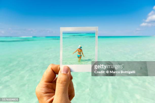 personal perspective of polaroid picture overlapping woman in tropical waters - greater antilles stock pictures, royalty-free photos & images