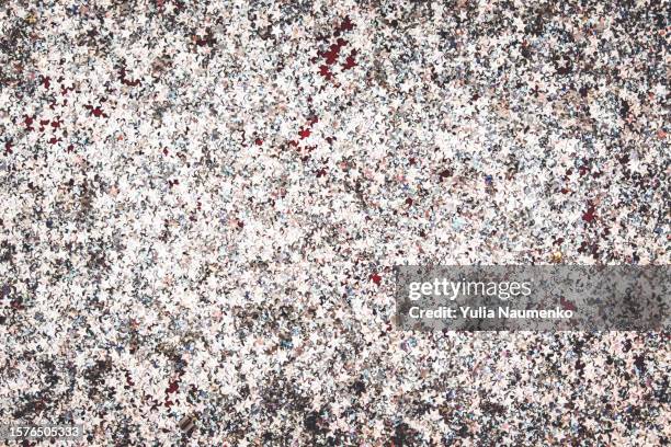 silver glitter in the form of stars on a dark red background. - grey backdrop stock pictures, royalty-free photos & images