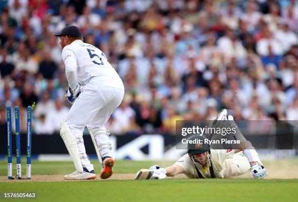 Steve Smith of Australia makes his ground as Jonny Bairstow of England knocks the bails off with his glove before receiving the ball during Day Two...