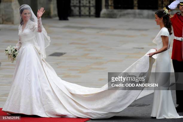 Kate Middleton waves as she arrives at the West Door of Westminster Abbey in London for her wedding to Britain's Prince William, on April 29, 2011....