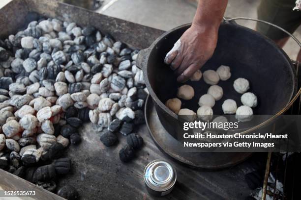 Boy Scout Troop, bakes a batch of pineapple biscuits in a dutch oven during the Scout Fair 2013, "The Best Scout Fair on Earth", at Reliant Arena on...