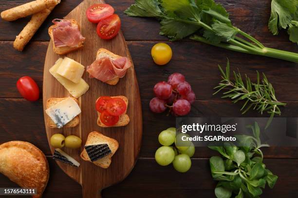 cheese and ham canapes with christmas decoration - christmas party canapes stock pictures, royalty-free photos & images
