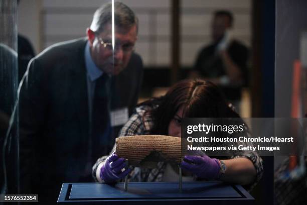 John Curtis, British Museum Keeper, views Wendy Adamson, Senior British Museum Assistant, install "The Cyrus Cylinder," an artifact from ancient...