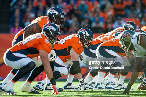 The Denver Broncos offensive line, including guard Chris Kuper and tackle Orlando Franklin line up against the Tampa Bay Buccaneers defense during a...