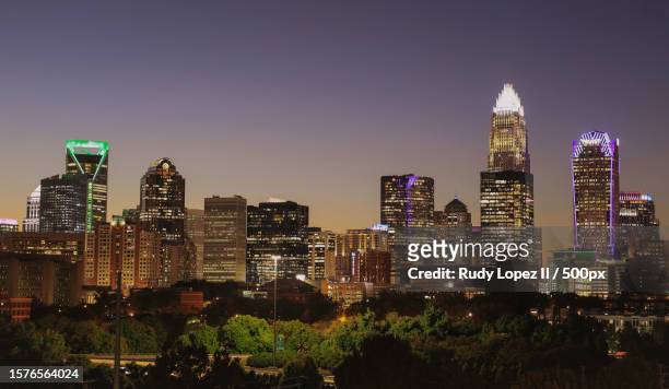 aerial view of illuminated buildings against sky at night,charlotte,north carolina,united states,usa - charlotte north carolina stock pictures, royalty-free photos & images