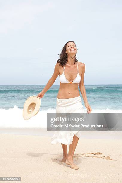 smiling woman - sarong stock-fotos und bilder