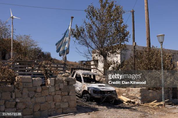 Burnt out car sits on a driveway on July 28, 2023 in Gennadi, Rhodes, Greece. While firefighting planes and helicopters are still dealing with...