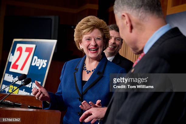 From left, Sens. Debbie Stabenow, D-Mich., Mark Begich, D-Alaska, and Chuck Schumer, D-N.Y., attend a news conference in the Capitol calling on the...