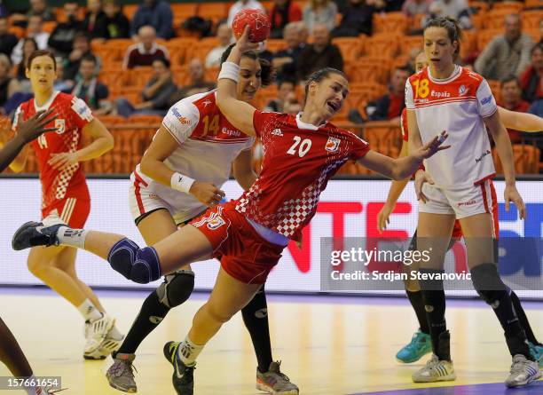 Vesna Milanovic of Croatia scores a goal near Begona Fernandez of Spain during the Women's European Handball Championship 2012 Group C match between...