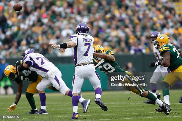 Christian Ponder of the Minnesota Vikings throws a pass while under pressure from Brad Jones of the Green Bay Packers at Lambeau Field on December 2,...
