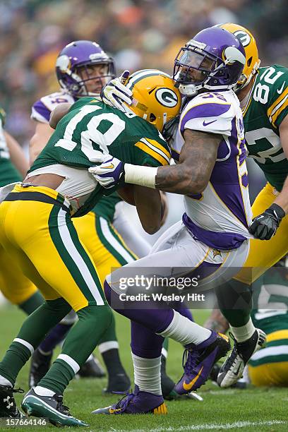 Randall Cobb of the Green Bay Packers is tackled by Marvin Mitchell of the Minnesota Vikings at Lambeau Field on December 2, 2012 in Green Bay,...