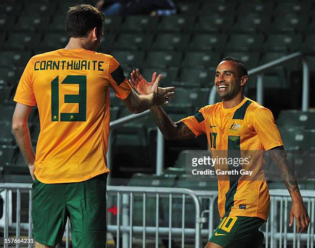 Robert Cornthwaite of Australia celebrates with team-mate Archie Thompson during the 2013 EAFF East Asian Cup Qualifying match between Korea DPR and...