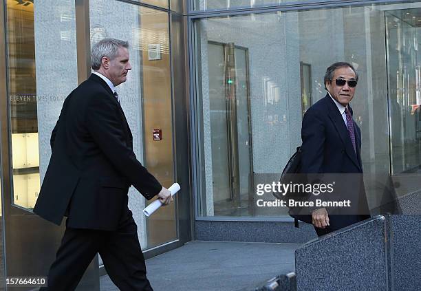 General Manager Garth Snow and team owner Charles Wang of the New York Islanders leave the leagues legal offices following the National Hockey League...