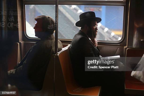 Passengers ride in a subway car two days after a man was pushed to his death in front of a train on December 5, 2012 in New York City. The incident...