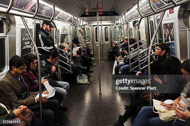 Passengers ride in a subway car two days after a man was pushed to his death in front of a train on December 5, 2012 in New York City. The incident...