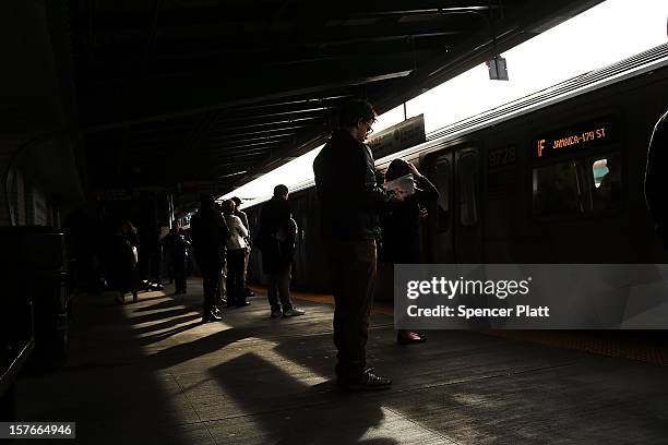 People wait for the subway at a stop in Brooklyn two days after a man was pushed to his death in front of a train on December 5, 2012 in New York...