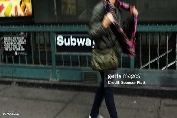 Pedestrian passes a subway stop in Manhattan two days after a man was pushed to his death in front of a train on December 5, 2012 in New York City....