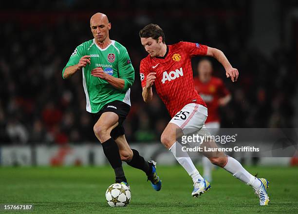 Nick Powell of Manchester United competes with Gabriel Muresan of CFR 1907 Cluj during the UEFA Champions League Group H match between Manchester...