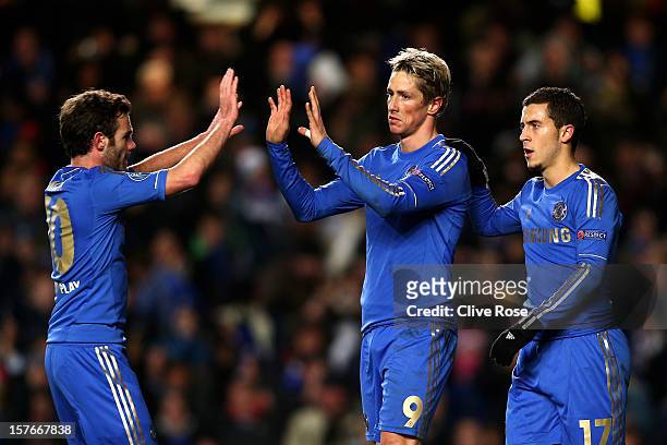 Fernando Torres of Chelsea is congratulated by teammates Juan Mata and Eden Hazard after scoring his team's second goal during the UEFA Champions...