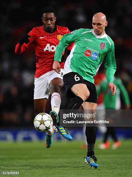 Danny Welbeck of Manchester United competes with Gabriel Muresan of CFR 1907 Cluj during the UEFA Champions League Group H match between Manchester...