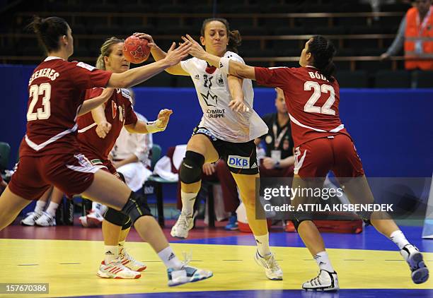 Germany's Kerstin Wohlbold vies with Hungary's Orsolya Verten and Zita Szucsanszki during the 2012 EHF European Women's Handball Championship match...